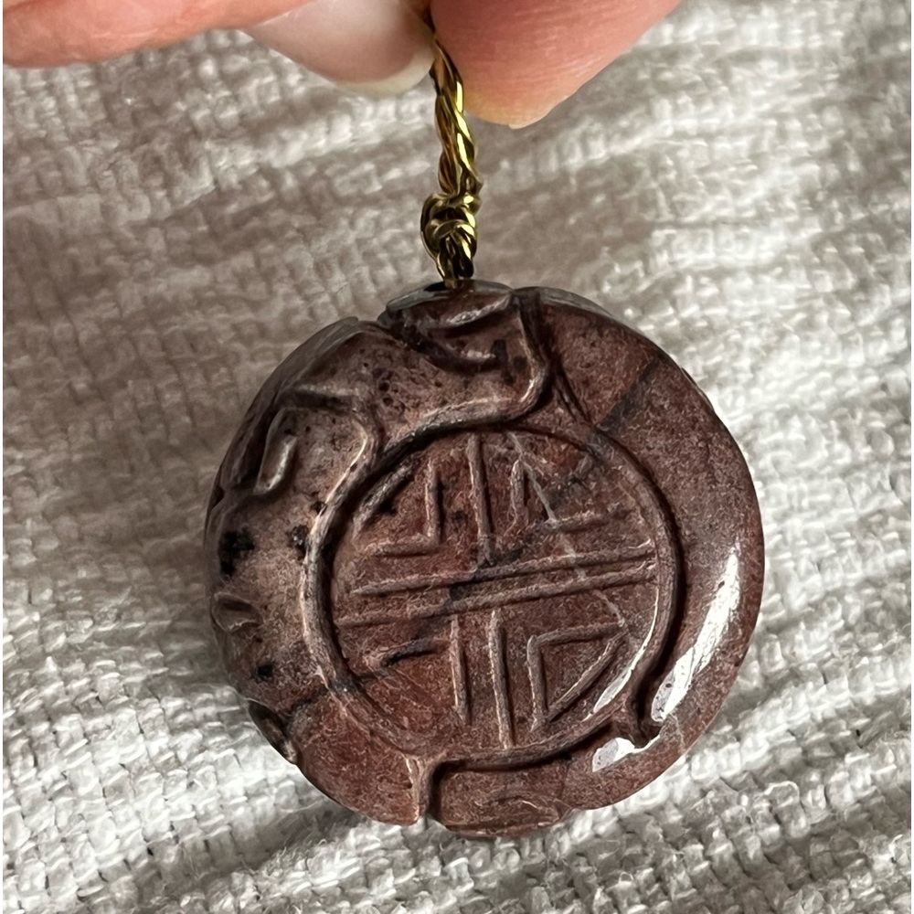 Hand carved stone pendant. Gold tone wire style bale. GUC!